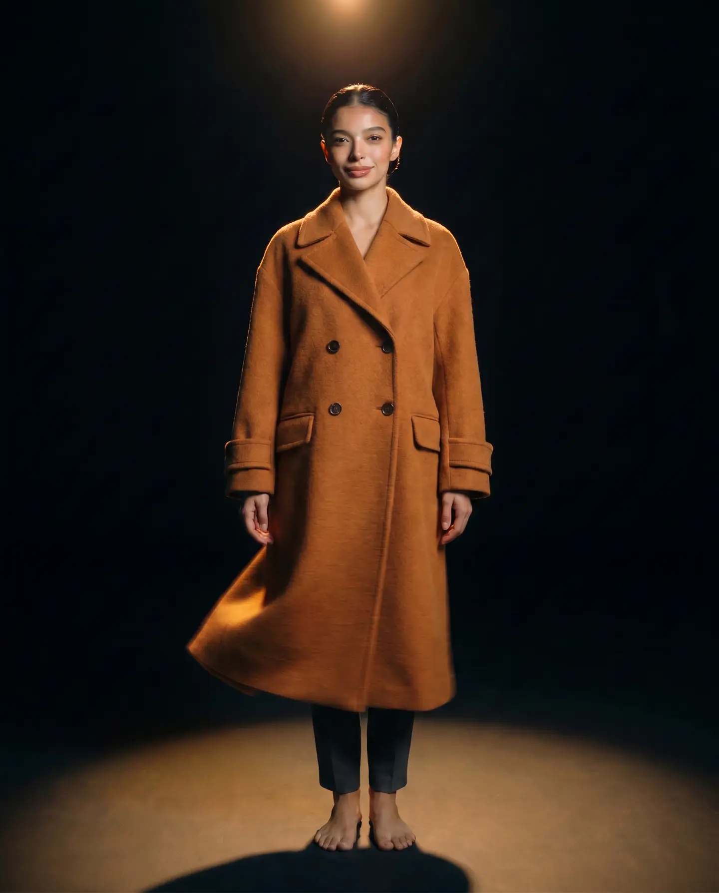 The same woman wearing the molten caramel coat